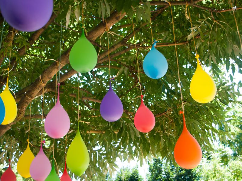 water filled balloons hung on a tree