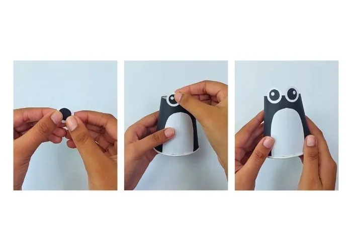 Attach paper cup penguin eyes